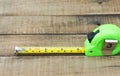 Tape measure on the brown wooden background Royalty Free Stock Photo