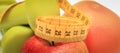 Tape measure, fresh fruits and dumbbells using in fitness. Slimming, healthy nutrition and sporty lifestyles Royalty Free Stock Photo