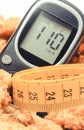 Tape measure, glucose meter with result sugar level and oatmeal cookies, diabetes and slimming concept