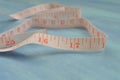 Tape measure half-rolled out. Measuring cm and inches. Tailoring tools. Pocket measure