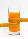 Tape measure meter on orange juice glass