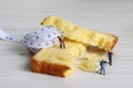 Tape measure and miniature workers on the bread. A concept about reducing carbohydrate intake.