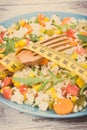 Tape measure and salad with vegetables and couscous groats. Light meal containing healthy vitamins and minerals