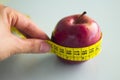 Tape measure surrounding a red apple Royalty Free Stock Photo