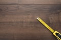 Tape measure on the brown wooden background Royalty Free Stock Photo