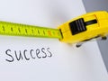 Tape Measure and the Word Success Written on a Royalty Free Stock Photo