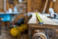 Tape measurer on long oak board in a small wood workshop