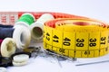 Tape measuring and spools of threads backgroun white