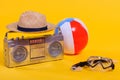 tape recorder, hat, beach ball and snorkel with scuba mask isolated on yellow Royalty Free Stock Photo