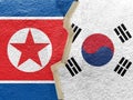 Tape on South Korea and North Korea flag on cracked wall