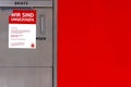 taped up gray metal mailbox with word letters above, red notice against white background on it in German tells about Royalty Free Stock Photo