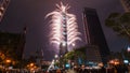 Taipei City Night landscape and Taipei 101 skyscraper is lit up by fireworks. People watching and taking photos and videos.