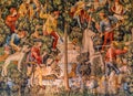 A tapestry of hunters hunting a unicorn