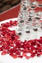 Tapioca pearls in champagne glass pyramid tower decorated with rose petals on white cloth table Royalty Free Stock Photo