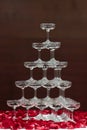 Tapioca pearls in champagne glass pyramid tower decorated with rose petals on white cloth table Royalty Free Stock Photo