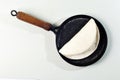 Tapioqueira maker with a tapioca inside top view, Iron skillet, cast iron skillet