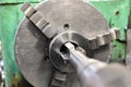 Tapping on a lathe, the tap cuts the hole by applying pressure from the tailstock