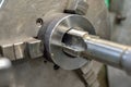 Tapping on a lathe, the tap cuts the hole by applying pressure from the tailstock