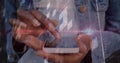 Tapping ringed hands in denim jacket navigating smartphone digital overlay, showing HUD circles Royalty Free Stock Photo