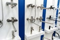 Taps for the bathroom. Plumbing trade in a specialized store. Large selection of products on display Royalty Free Stock Photo