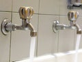 taps in stainless steel on the washbasin with water