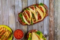 Taquitos, soft tortillas and salsa on wooden table