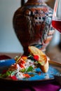 Tar tar with croutons on a blue dish with a jug Royalty Free Stock Photo