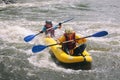 Young couple enjoy white water kayaking on the river