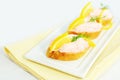 Taramasalata canape fish-roe spread bites with lemon slices over bread