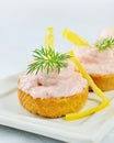 Taramasalata canape, fish-roe spread bites with lemon slices