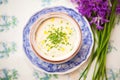 taramasalata in a decorative dish with chives sprinkled on top