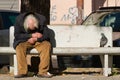 Taranto, Apulia / Italy - 03/23/2019 : A lost homeless old man depressed on bench