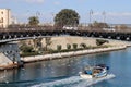 Taranto swing bridge with fishing boat returning to the port surrounded by dozens of seagulls. Puglia, Italy