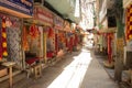 shops with spiritual items at the narrow street with sun beam sipping through the narrow escape