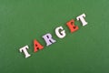 TAREGET word on green background composed from colorful abc alphabet block wooden letters, copy space for ad text. Learning