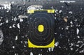 Target centered on a black background with bullet holes for shooting sports with rifles and handguns.