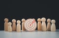 Target concept of business and personnel in a company. wooden dolls standing around Dart board and arrows for creating and Royalty Free Stock Photo