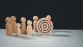 Target concept of business and personnel in a company. wooden dolls standing around Dart board and arrows for creating and Royalty Free Stock Photo