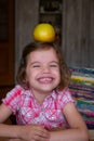 Target concept - little kid girl with the apple on the head Royalty Free Stock Photo