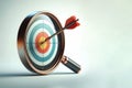 A target with a dart in the center through a magnifying glass. Space for text. Royalty Free Stock Photo