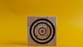 Target icon on wooden cubes, yellow background. Target concept