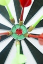 Target with red and green darts stuck in the center Royalty Free Stock Photo