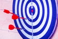 Targets for archery on a green background. Three red darts in the target. Royalty Free Stock Photo