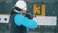 Targets on a panel are closing after lady biathlete shooting them