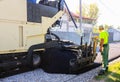 Targoviste, Romania - 2019. Close view on a worker operating asphalt paver machine during road construction. Construction of a new Royalty Free Stock Photo