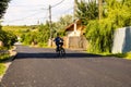 Targoviste, Romania - 2019. Young boy riding bike with no hands along a new road with fresh asphalt