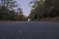 Tarmac road through Anshi forest at twilight, India. Royalty Free Stock Photo