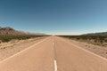 Tarmac road vanishes into the distance in the desert of San Juan, Argentina.