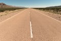 Tarmac road vanishes into the distance in the desert of San Juan, Argentina.