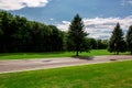 Tarmak road wet after rain surrounded by an environment of green. Royalty Free Stock Photo